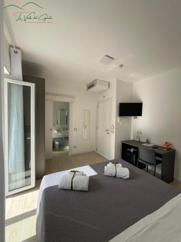 a bedroom with a large bed with a desk and a desk at La valle del ciglioto in Licusati