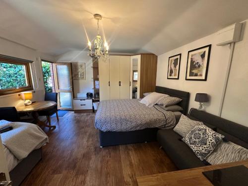 a bedroom with a bed and a couch at Station Approach Solihull Cabin Stays in Solihull