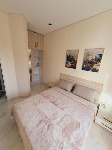 a bedroom with a large bed with two pictures on the wall at Jasmine in Sharm El Sheikh