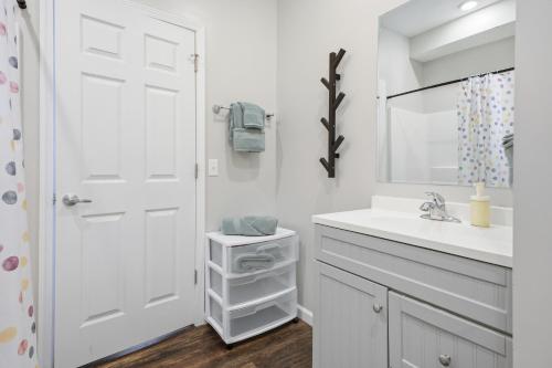 a white bathroom with a sink and a mirror at Sun Valley Courtyard, No Steps in Saint Joseph