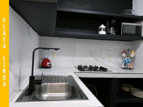 a kitchen with a sink and a stove at Casa de 4 habitaciones con alberca in Barrio Nuevo