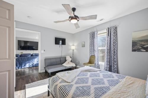 a bedroom with a bed and a ceiling fan at Sun Valley Loft, Close to Mosaic! in Saint Joseph