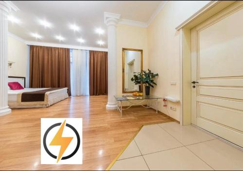a large room with a bed and a door at Corona Hotel & Apartments in Odesa