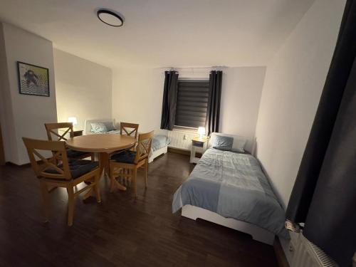 a bedroom with a bed and a table and chairs at Ferien- und Monteurwohnung in Borna Nr 5 in Borna