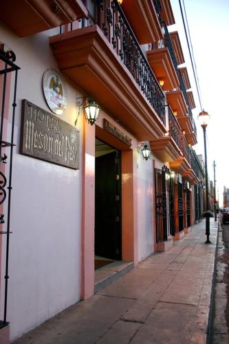 a building with a sign on the side of a street at Hotel Mesón del Rey in Oaxaca City