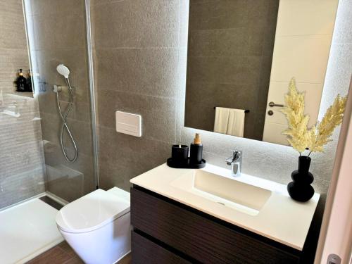 a bathroom with a sink and a toilet and a shower at Alcazaba Lagoon & Private Beach Costa del Sol 1903 in Estepona
