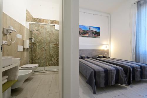 a bedroom with a bed and a bathroom at La Piazza in Ancona