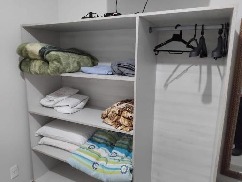 a white closet with towels and towels at 502 edificio premieri in Piratuba