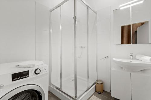 a white bathroom with a washing machine and a sink at U1 Metro Nearby - 1-BR - fast Wi-Fi in Vienna