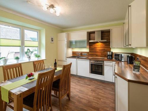 a kitchen with a table and chairs and a dining room at Apartment Alexandra by Interhome in Wintrich