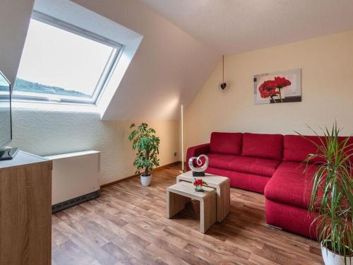 a living room with a red couch and a window at Apartment Alexandra by Interhome in Wintrich