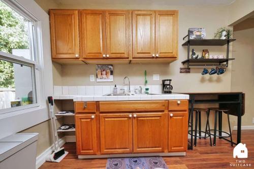 a kitchen with wooden cabinets and a sink at Central Berkeley Garden Oasis in Berkeley