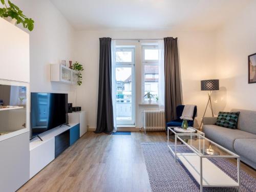 a living room with a couch and a tv at Apartment Apartment 54 by Interhome in Bad Arolsen