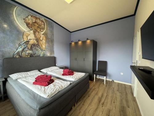 a bedroom with a bed with a painting on the wall at Holiday Home Feriendorf E44 by Interhome in Husen