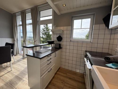a kitchen with a stove and a counter top at Holiday Home Feriendorf E44 by Interhome in Husen