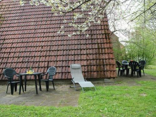 a group of chairs and tables in front of a house at Holiday Home Kirschblüte by Interhome in Ronshausen
