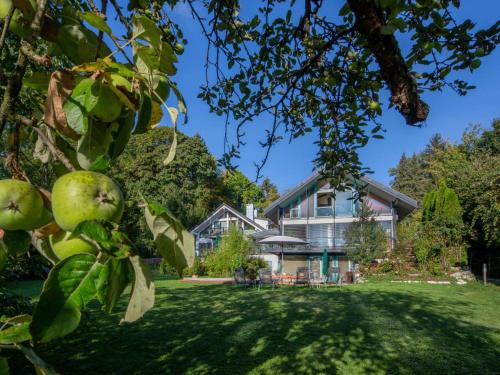 an apple tree in front of a house at Apartment Immas Welt by Interhome in Utting am Ammersee