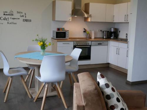 a kitchen and dining room with a table and chairs at Apartment Kommerswag by Interhome in Pittenbach