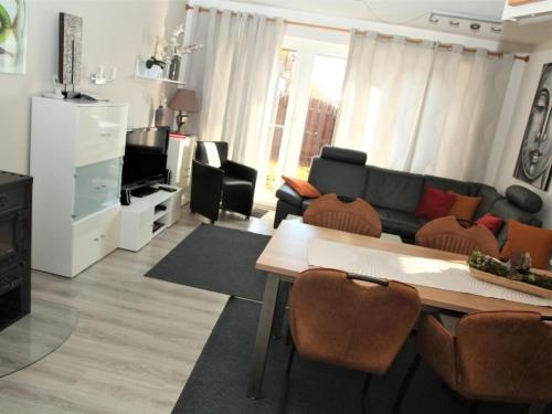 a living room with a couch and a table at Holiday Home Adele - Allergiker geeignet by Interhome in Zandt
