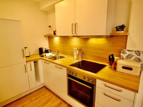 a kitchen with a sink and a stove top oven at Apartment Feldblick by Interhome in Hartheim