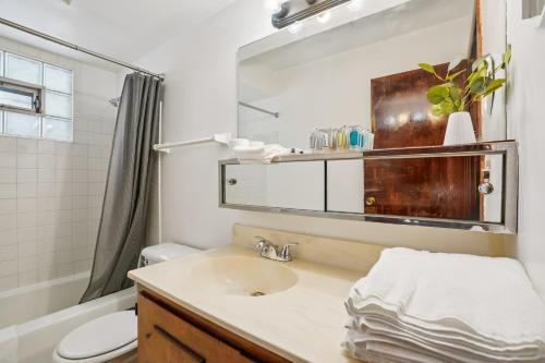 a bathroom with a sink and a toilet and a mirror at CBI Haven 1 & 2 in Milwaukee