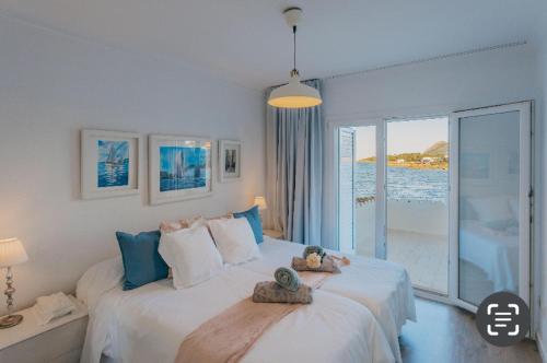 a bedroom with a large bed with a view of the ocean at CASA PRINCESA in Alcudia