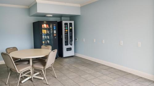 a dining room with a table and chairs and a refrigerator at Gated 2 Double Beds Studio with Full Kitchen 122 in Baton Rouge