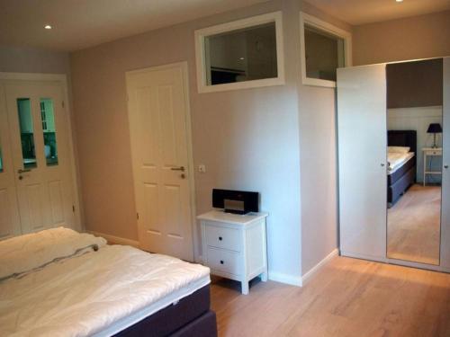 a bedroom with a bed and a desk with a television at Apartment Seerose by Interhome in Bleckede
