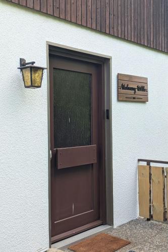 a brown door with a sign on the side of a building at Apartment Wittle by Interhome in Weiler-Simmerberg