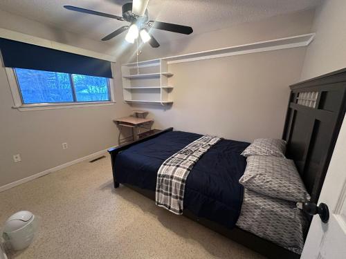 a bedroom with a bed and a ceiling fan at 3 Private rooms with built-in closet & desk in Edmonton