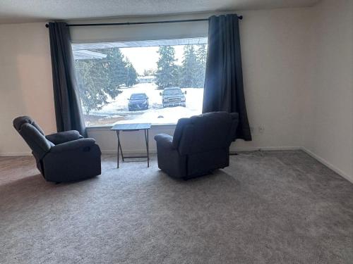 two chairs and a table in a room with a window at 3 Private rooms with built-in closet & desk in Edmonton