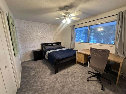 a bedroom with a bed and a desk and a window at 3 Private rooms with built-in closet & desk in Edmonton