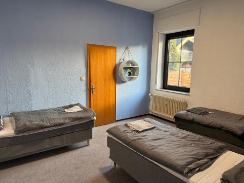 a room with two beds and a window at Bettina City Flat - Ground Floor in Werne an der Lippe