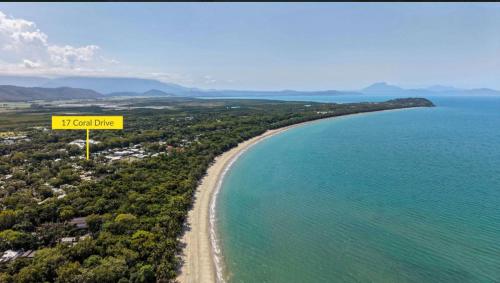 a sign that reads tgi coral line next to a beach at Villa Coral - Tropical Oasis Footsteps to Four Mile Beach in Port Douglas