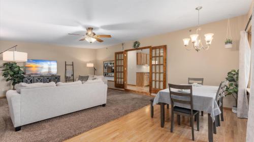 a living room with a white couch and a table at 2BR Condo by Lake w Deck, Jetted Tub - Raindrop in Pepin