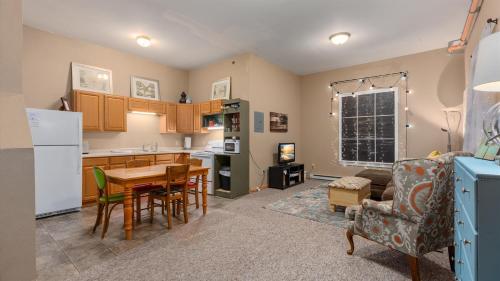 a kitchen and living room with a table and a refrigerator at Three Connected Quirky Condos By Beach! - Twilight Condo in Pepin
