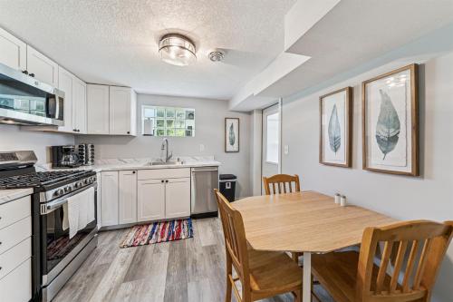 a kitchen with a wooden table and a dining room at Cozy 2BR Garden Apartment Near Lake Pepin - Daisy in Pepin