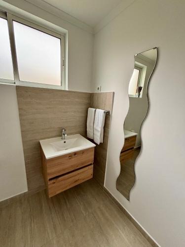 a bathroom with a sink and a mirror at Santos Living Rentals in Funchal