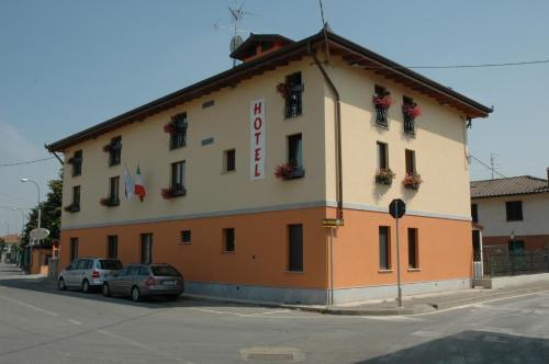 a building with cars parked in front of it at Hotel Il Borghetto in Bariano
