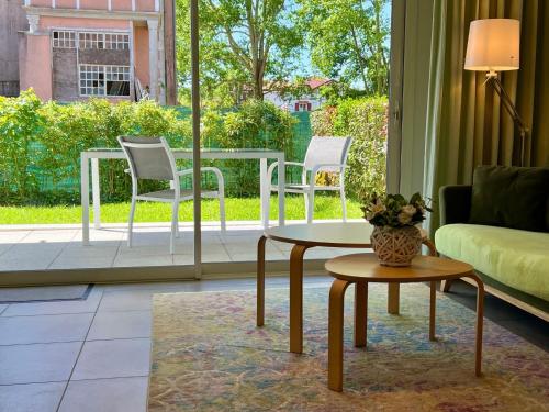 a living room with a couch and a table and chairs at Apartment by Interhome in Cambo-les-Bains