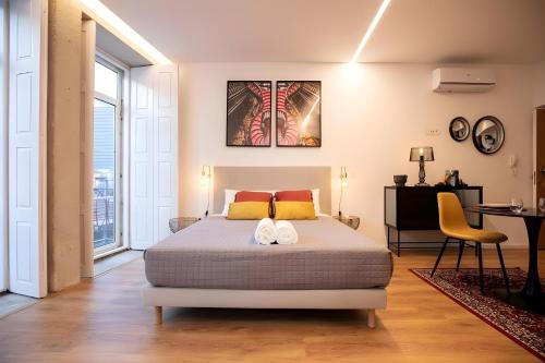 a bedroom with a bed with two white towels on it at Lemago Porto Apartments - Poveiros in Porto