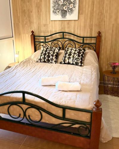 a bedroom with a bed with two towels on it at Ocean Hill House by Rentery Madeira in Santa Cruz