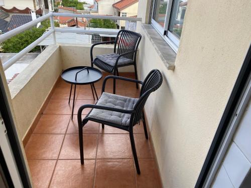 two chairs and a table on a balcony at Sweet home in Entroncamento