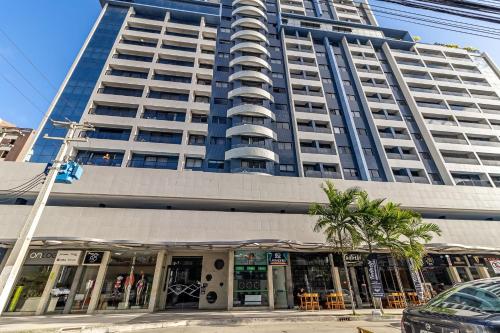 a tall building with a store in front of it at STUDIO/ESTÚDIO TOP - Praia 200M & Lazer Incrível / Stylish Stúdio - 200M Beach & Great Amenites in Maceió
