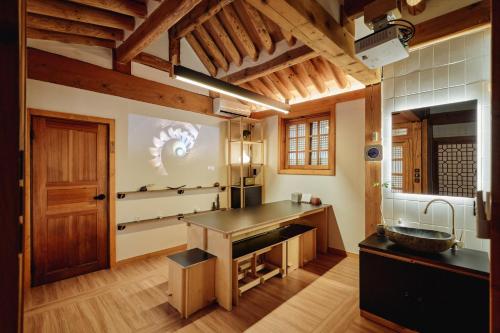 a kitchen with a counter and a sink in a room at THE CHAE Premium Hanok Stay in Seoul