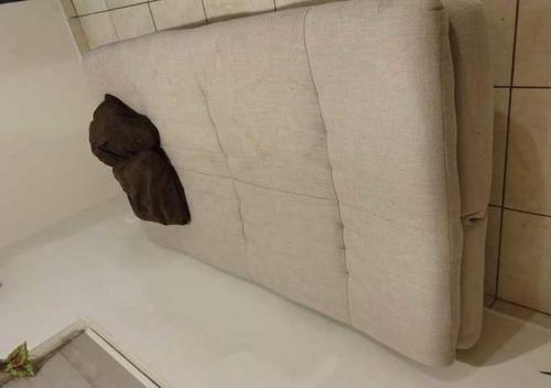 a white couch with a stuffed animal on it at Casa centrica y acogedora para tu visita a Hermosillo in Hermosillo
