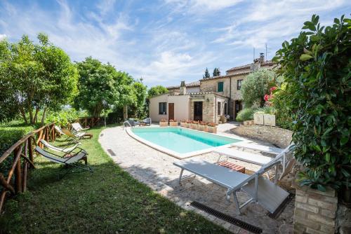 a swimming pool in the yard of a house at BorgoCuore in Todi