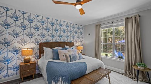 a bedroom with a bed with blue and white wallpaper at 30A Cottage Near the Beach with Golf Cart in Inlet Beach