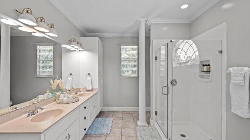 a bathroom with two sinks and a shower at 30A Cottage Near the Beach with Golf Cart in Inlet Beach