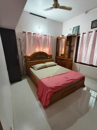 a bedroom with a bed with a red blanket at Cozy Nest in Pūvār